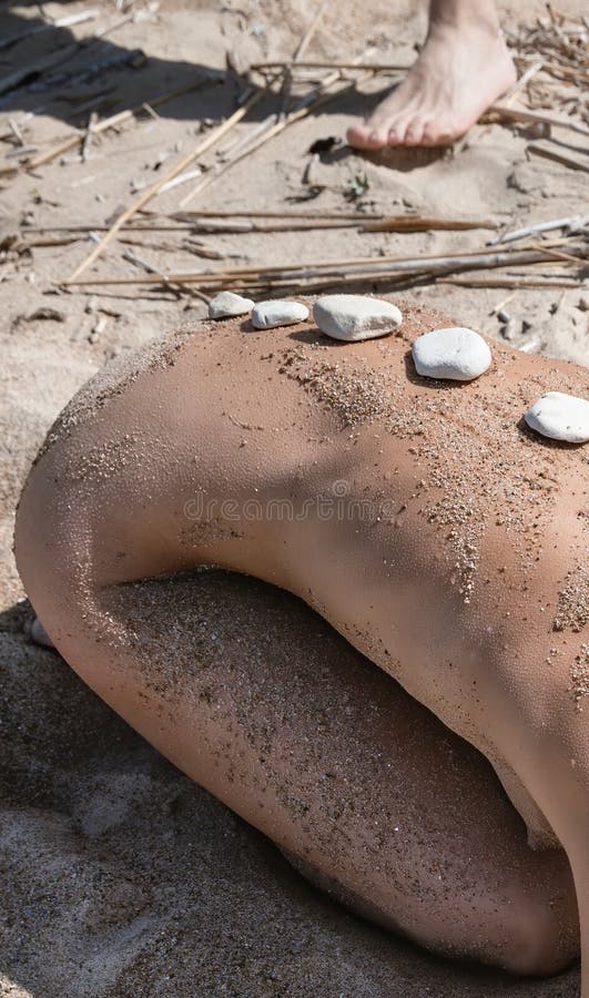 Naked Woman with Hot Stones Treatment on Sandy Beach Stock Image