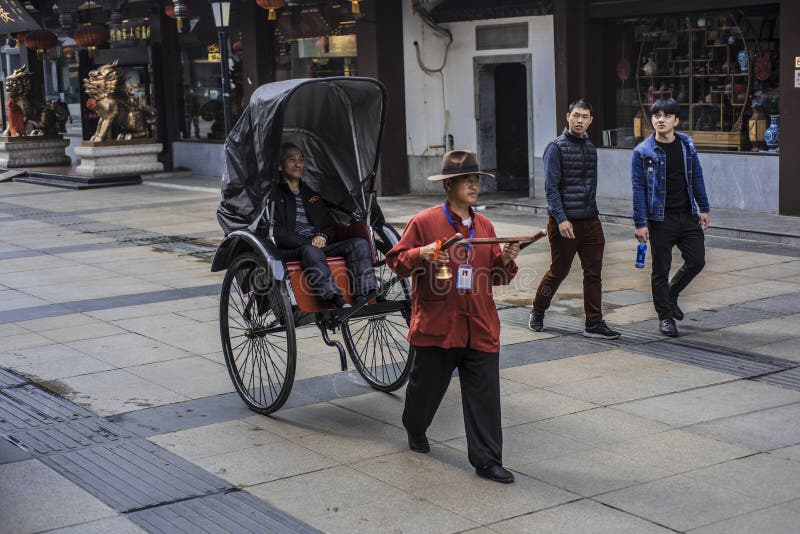 A man who pulls a rickshaw in nanjing Confucius temple. royalty free stock images
