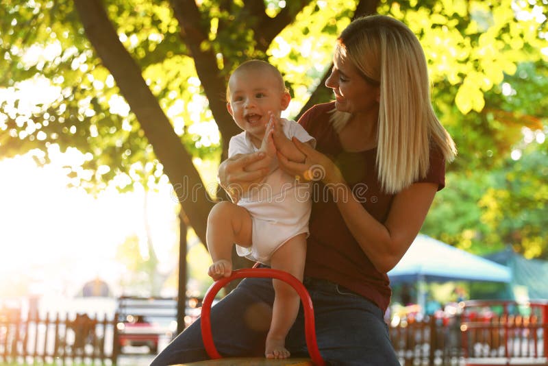 Nanny and cute baby sitting on outdoors royalty free stock photography Nanny and cute baby sitting on outdoors royalty free stock photography