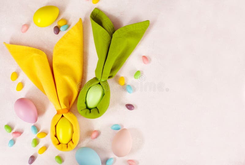 Napkin Easter Bunny, Decoration Eggs and Easter Candy on Pink