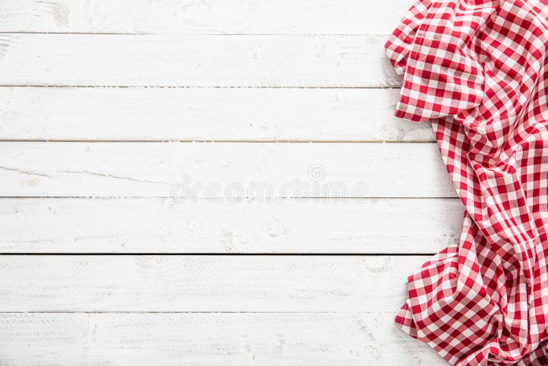 Red checkered kitchen tablecloth on wooden table. Red checkered kitchen tablecloth on wooden table.