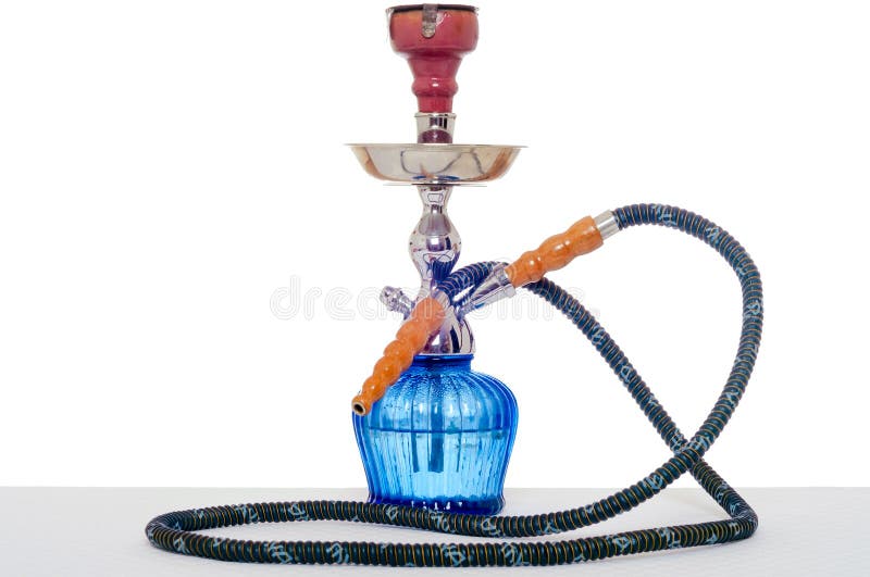 Hookah at white background. Smoking device on table in light interior. Hookah at white background. Smoking device on table in light interior.