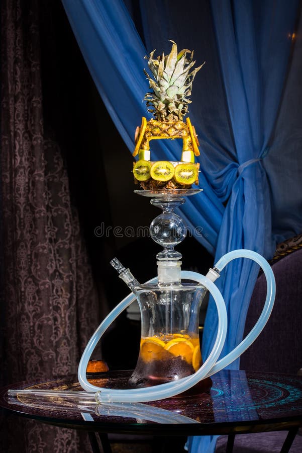 Exotic hookah with the pineapple on the top over blue background. Exotic hookah with the pineapple on the top over blue background