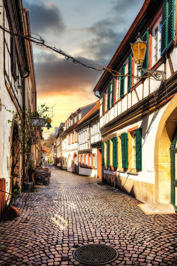 Narrow street in the old town of Neustadt an der Weinstrasse in the Pfalz at sunset, Germany.