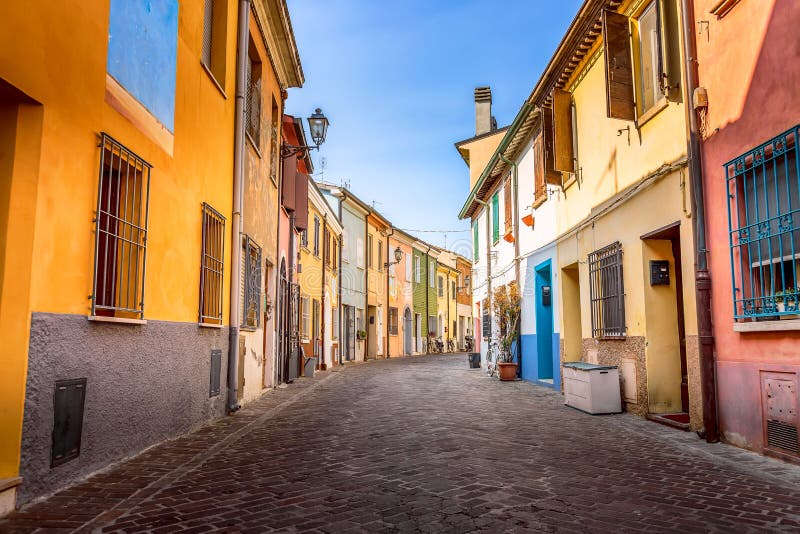 Narrow street of the village of fishermen San Guiliano with colorful houses and bicycles in early morning in Rimini, Italy royalty free stock photos Narrow street of the village of fishermen San Guiliano with colorful houses and bicycles in early morning in Rimini, Italy royalty free stock photos