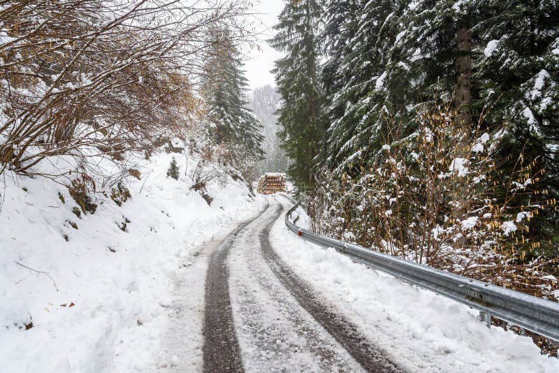 Narrow winding mountain road covered in snow royalty free stock photos