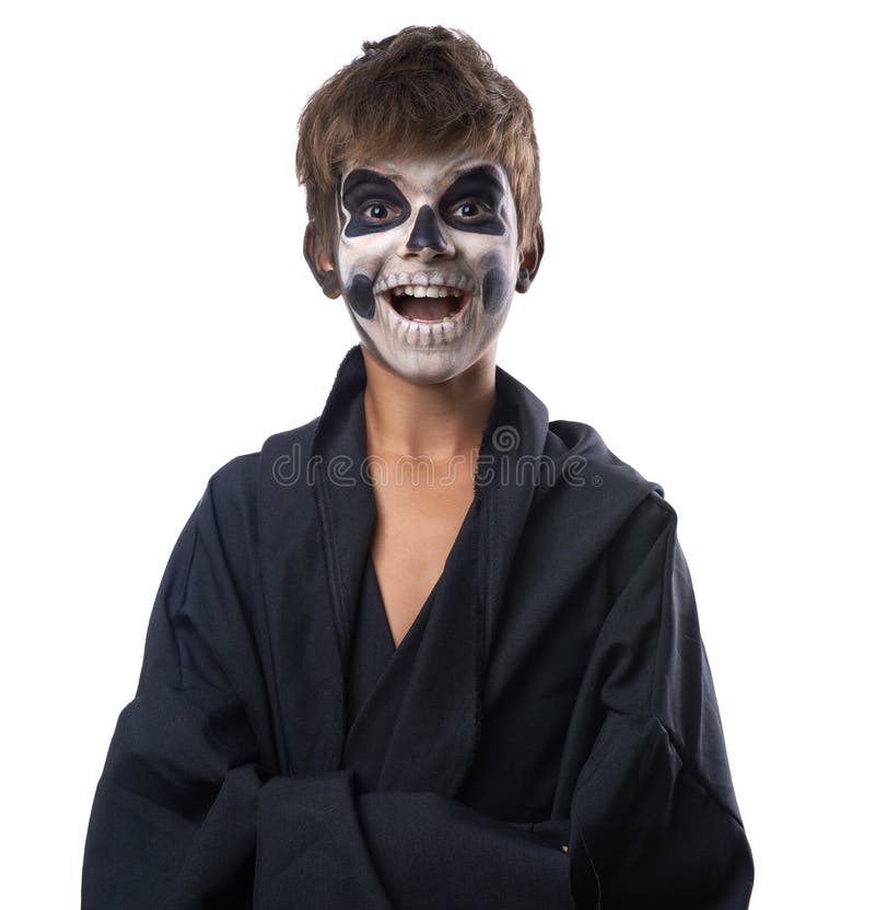 Teen with make-up of the skull in a black cloak laughs. Teen with make-up of the skull in a black cloak laughs