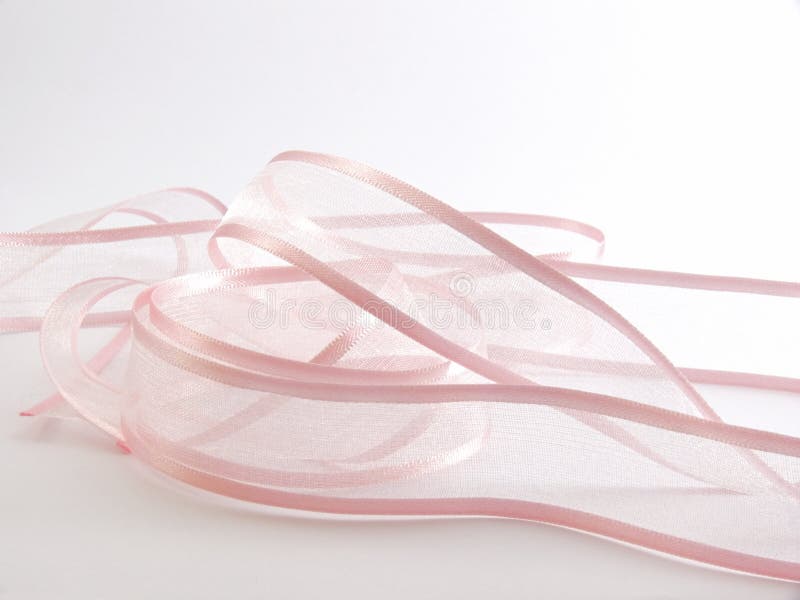 A pink fabric ribbon on a white background. A pink fabric ribbon on a white background