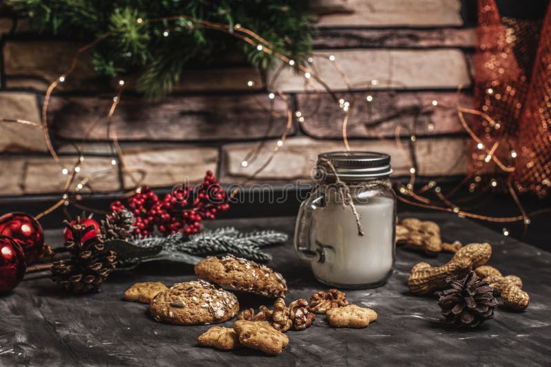 Natale e fondo della decorazione della tavola del nuovo anno con la ghirlanda, i biscotti, le pigne, i wallnuts e la candela in t immagini stock libere da diritti Natale e fondo della decorazione della tavola del nuovo anno con la ghirlanda, i biscotti, le pigne, i wallnuts e la candela in t immagini stock libere da diritti