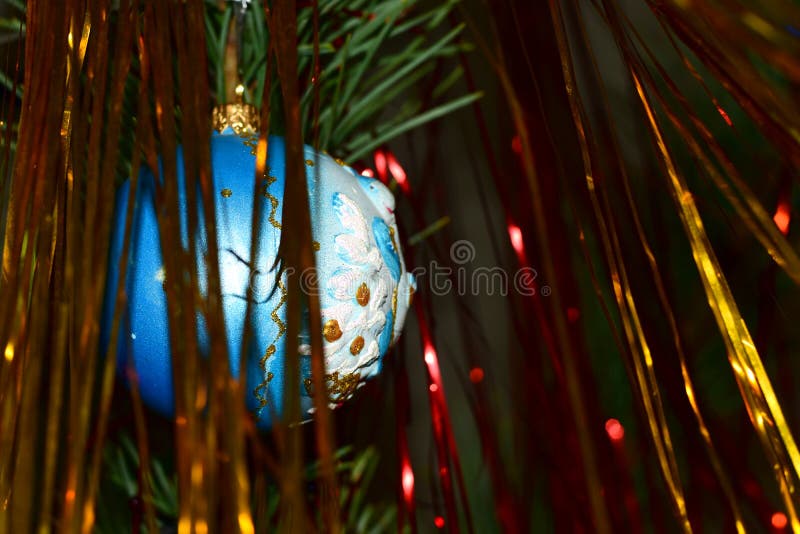 Christmas. On the branches of the Christmas tree, there are a shiny ball and a shiny bagura hanging. Christmas. On the branches of the Christmas tree, there are a shiny ball and a shiny bagura hanging.