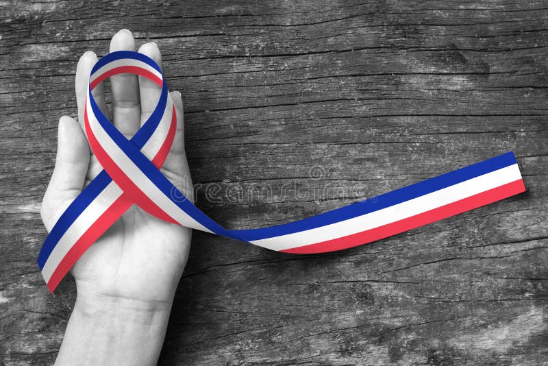 National flag pattern ribbon on person`s hand support isolated with clipping path symbolic icon for nation support. Patriotic remembrance and Bastille day stock images National flag pattern ribbon on person`s hand support isolated with clipping path symbolic icon for nation support. Patriotic remembrance and Bastille day stock images