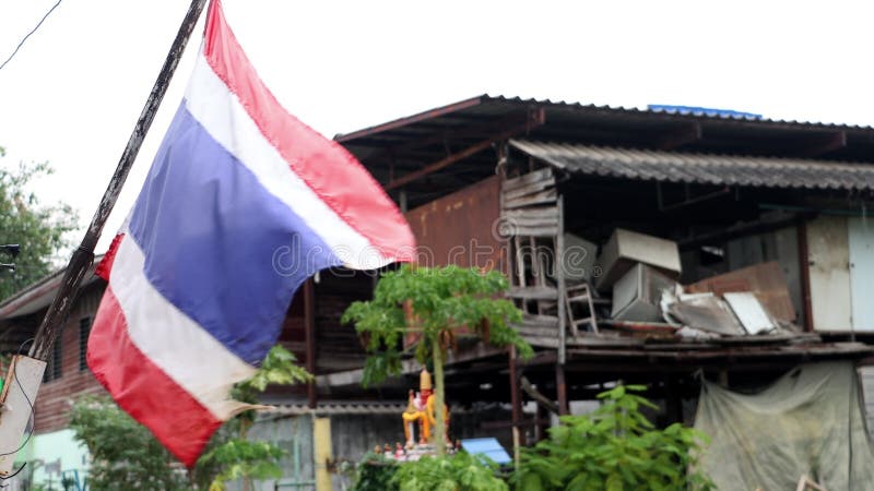 The national flag of Thailand flutters on the street