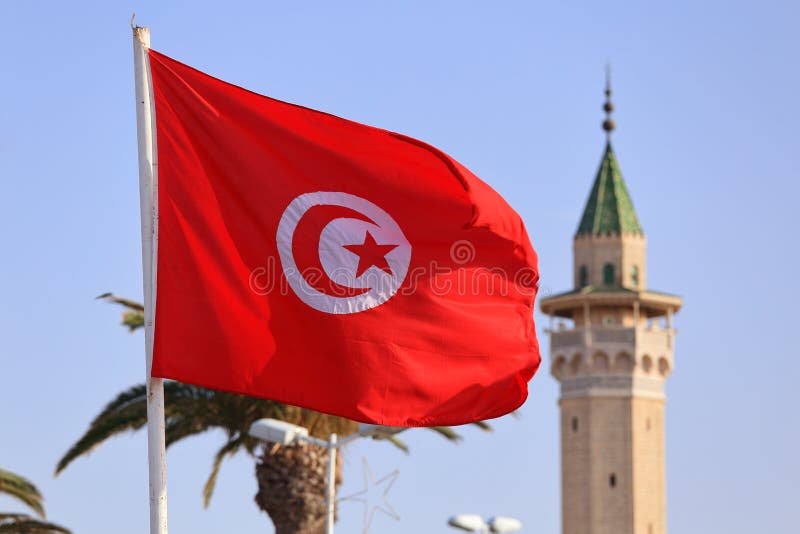 The national flag of Tunisia against the blue sky royalty free stock images The national flag of Tunisia against the blue sky royalty free stock images