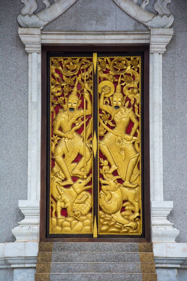 Native Thai style carving, painting on church door in Thai temple