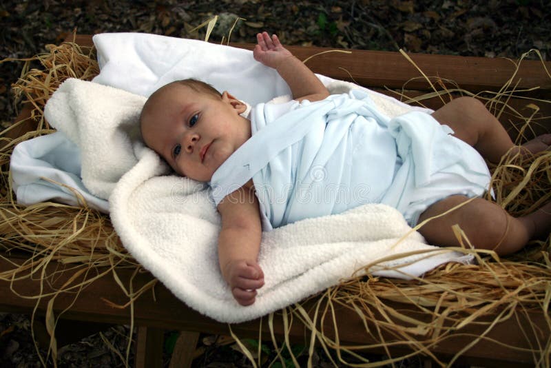 Baby in manger in swaddling clothes. Baby in manger in swaddling clothes