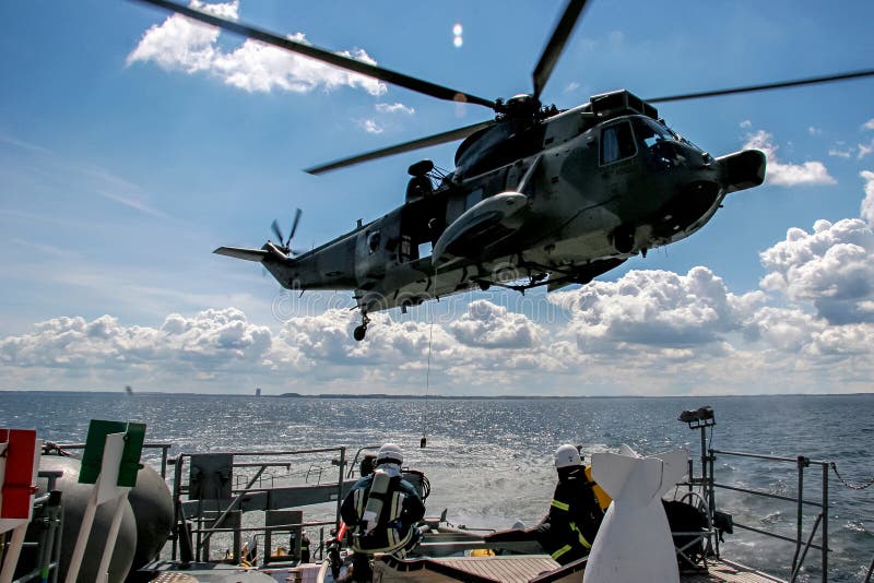NATO rescue mission in sea with ship and helicopter