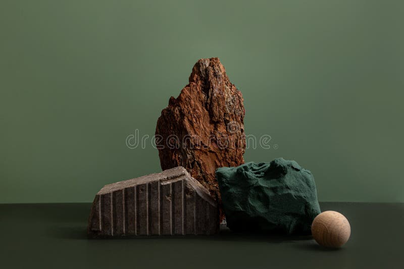 Natural background podium for cosmetic products created from wood, bark and paper on green background. Creative modern royalty free stock photography