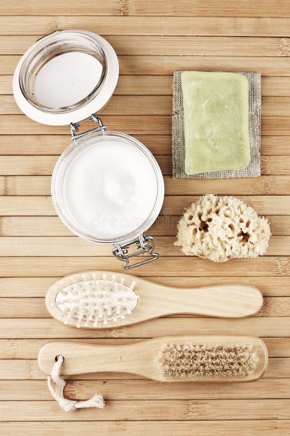 Natural bath accessories on wooden background: cosmetic cream, wood brushes, sponge and soap bar. SPA still life. Top view point, royalty free stock photos Natural bath accessories on wooden background: cosmetic cream, wood brushes, sponge and soap bar. SPA still life. Top view point, royalty free stock photos