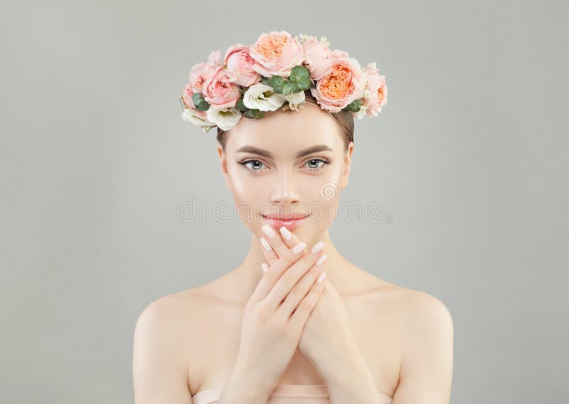 Natural beauty. Cute woman with healthy skin, manicured nails and roses flowers wreath royalty free stock images Natural beauty. Cute woman with healthy skin, manicured nails and roses flowers wreath royalty free stock images