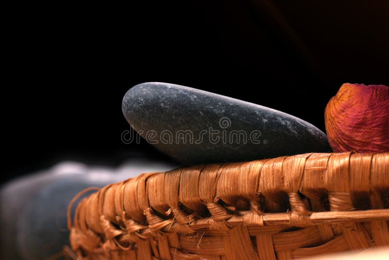 Natural bebbles and dried flowers on the rattan background