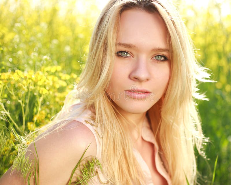 Natural close up portrait of a attractive girl in spring meadow