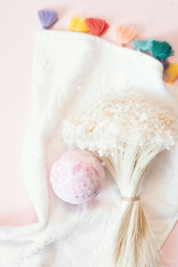 Natural cosmetics. Bath bomb, flowers and towel on pink pastel background stock image Natural cosmetics. Bath bomb, flowers and towel on pink pastel background stock image
