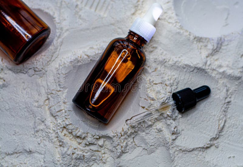 Natural Cosmetics Face Oil in Brown Bottle on the Sand Stock Photo