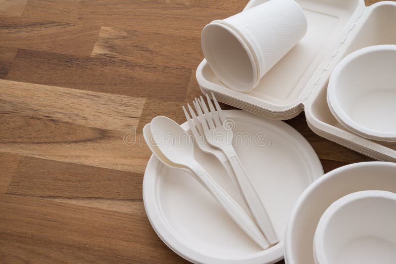 Natural eco-friendly disposable utensils fork, spoon, dish plate, bowl, cup and fast food box container made of fiber of bagasse