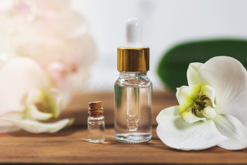 Natural flower essential oil bottles with orchid blossom