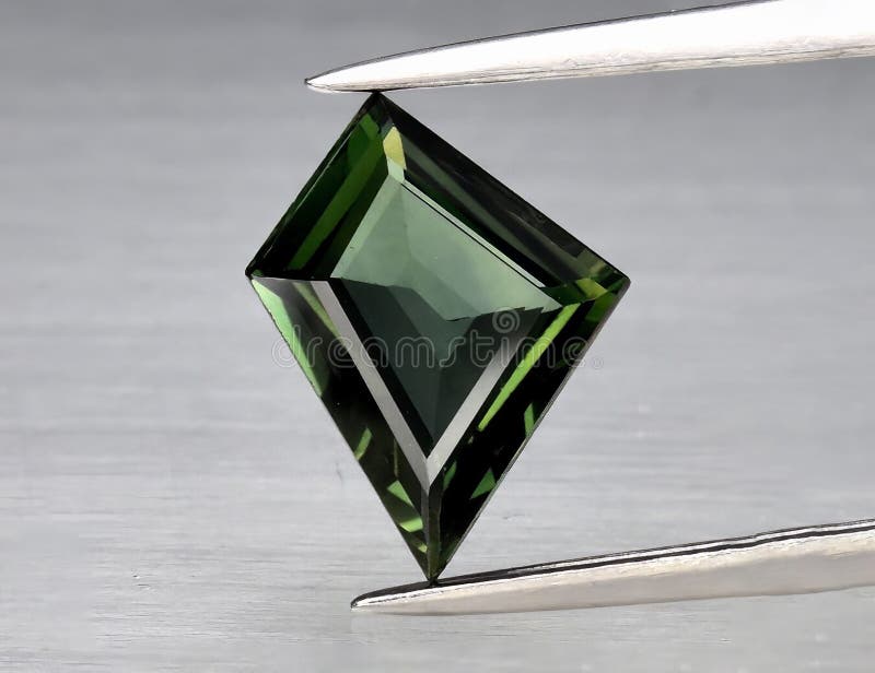Natural gemstone green sapphire on gray background royalty free stock photos
