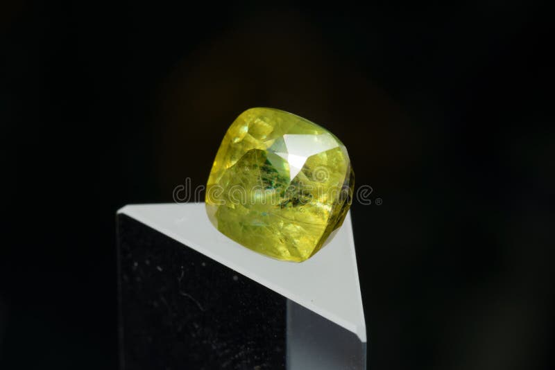 Natural gemstone sphene on black background stock photos