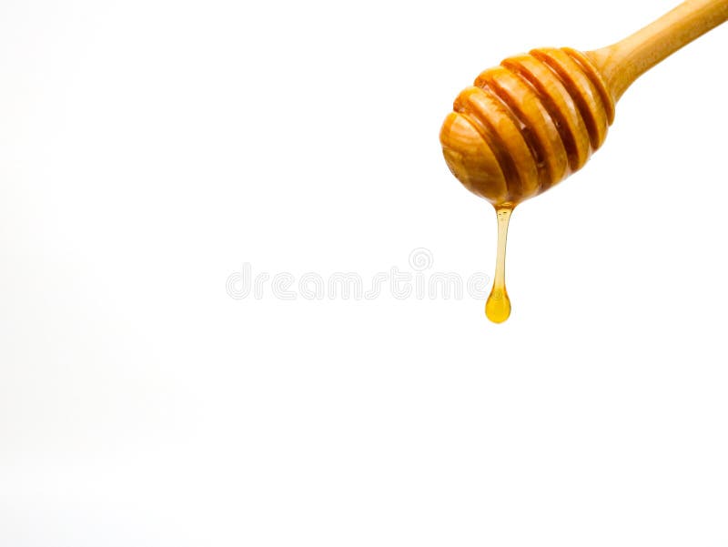 Natural honey dripping from dipper on white background royalty free stock photos