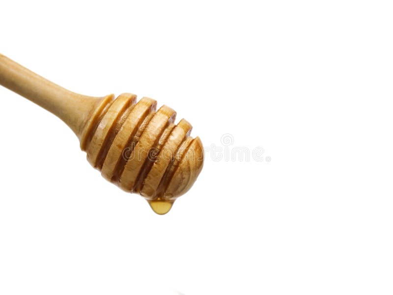 Natural honey dripping from dipper on white background royalty free stock image