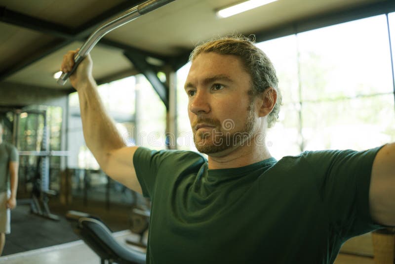Natural lifestyle portrait of young athletic and attractive man training and body building doing muscular exercise with gym royalty free stock photo Natural lifestyle portrait of young athletic and attractive man training and body building doing muscular exercise with gym royalty free stock photo
