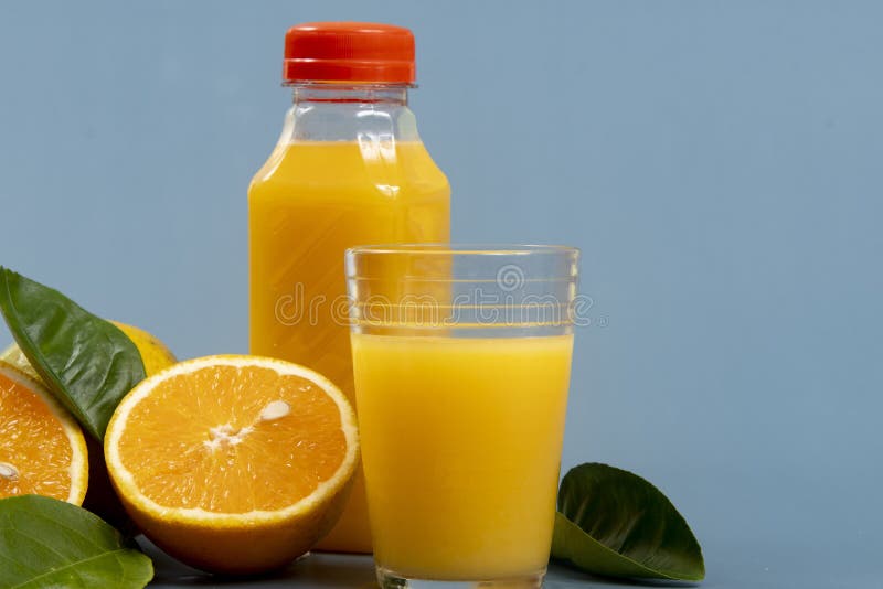 Natural orange juice in the glass with bottle on the side. stock photography