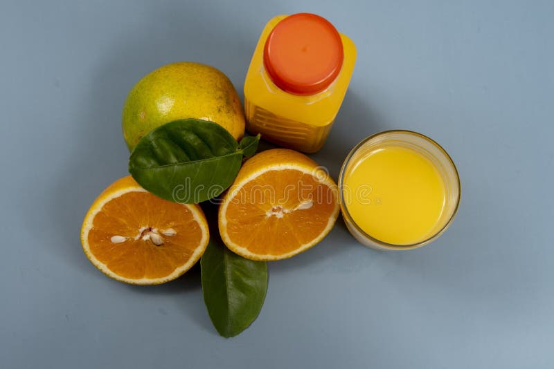 Natural orange juice in the glass with bottle on the side. royalty free stock image