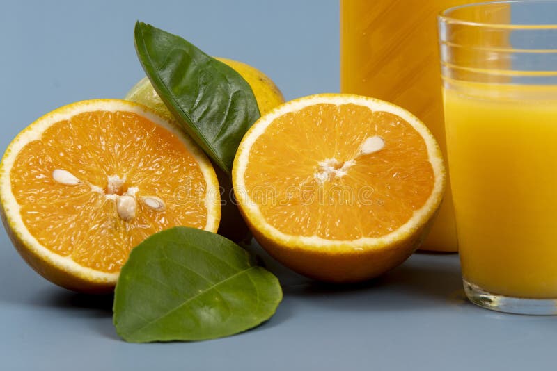 Natural orange juice in the glass with bottle on the side royalty free stock photography