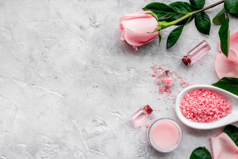 Natural organic cosmetics with rose oil. Cream, lotion, spa salt on grey background top view copyspace royalty free stock image Natural organic cosmetics with rose oil. Cream, lotion, spa salt on grey background top view copyspace royalty free stock image