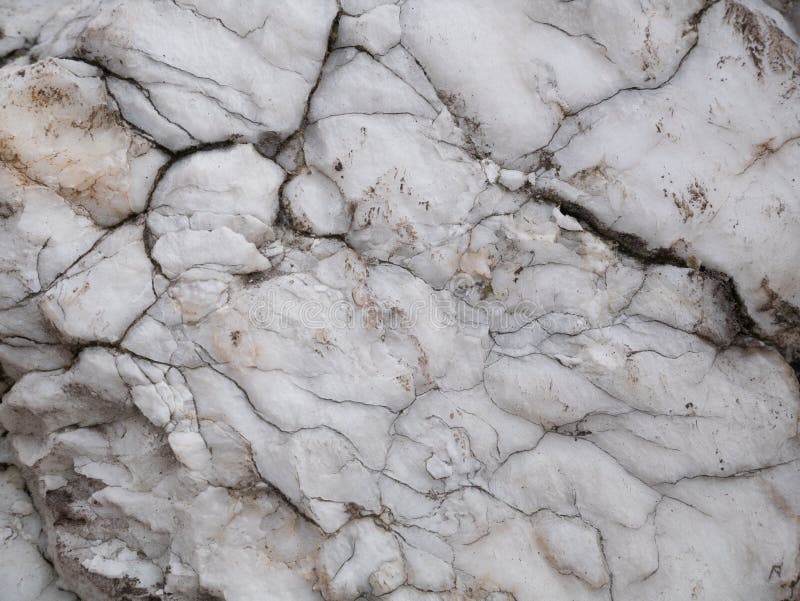 Natural Pattern of Weathered White Marble Stone with Cracks. Closeup
