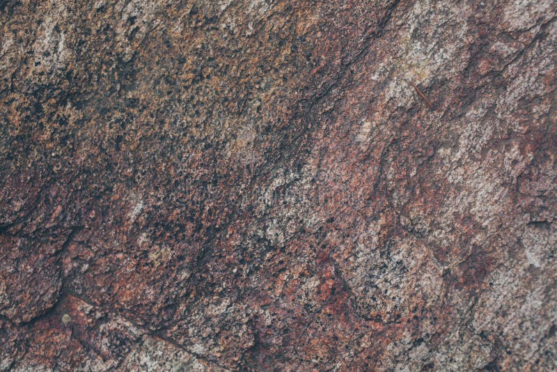 Natural rock wall texture and background.Brown old stone surface textured. Closeup view of stone wall texture and background.