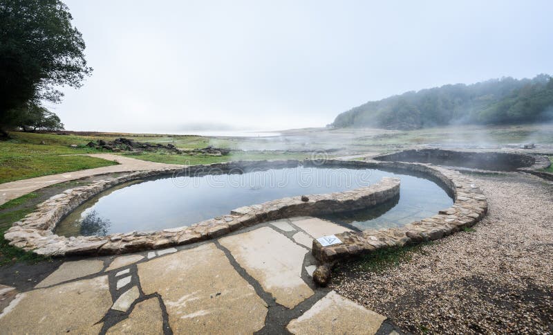Natural Roman baths outdoors with hot steam and thermal water