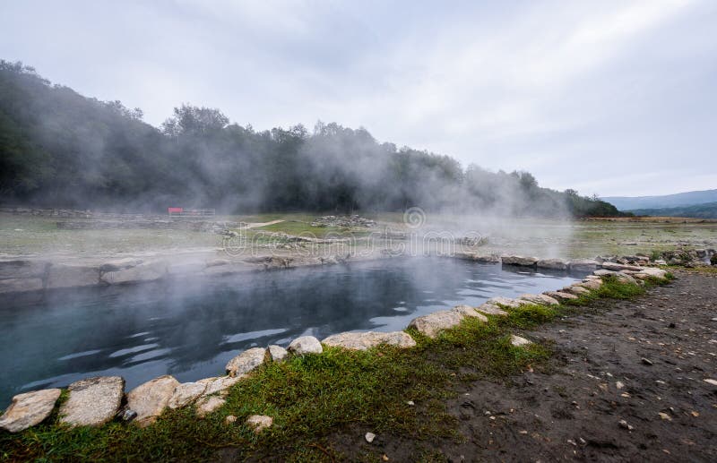 Natural Roman baths outdoors with hot steam and thermal water