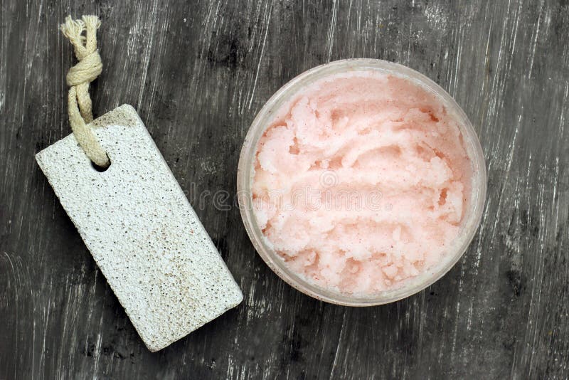 Natural scrub in container and stone on grey background, top view. Clear closeup view stock images, royalty-free photos and pictures