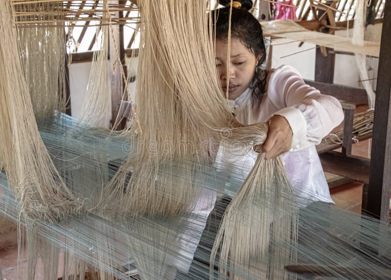 Natural silk farming and handcrafted manufacture of silk artifacts -ladies handweaving ancient patterns in silk on traditional lo