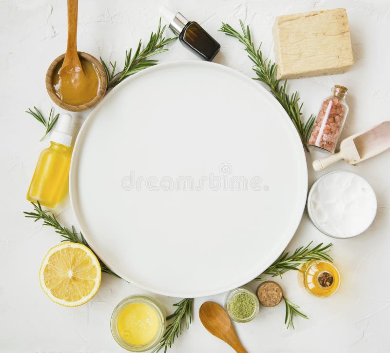 Natural skincare products with oils, herbs, manuka honey and round plate copy space
