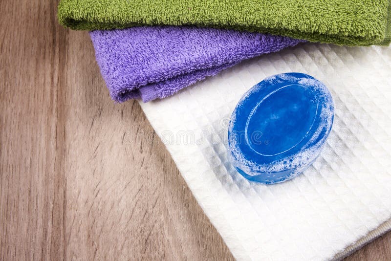 Natural Soap Bar and Bubble with Bath Towel on Wooden Background Stock