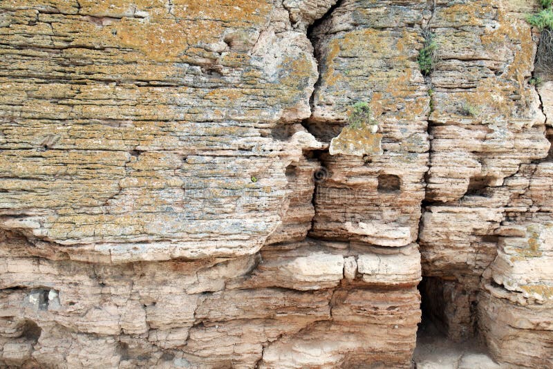 Natural stone wall texture, rock with cave entrance