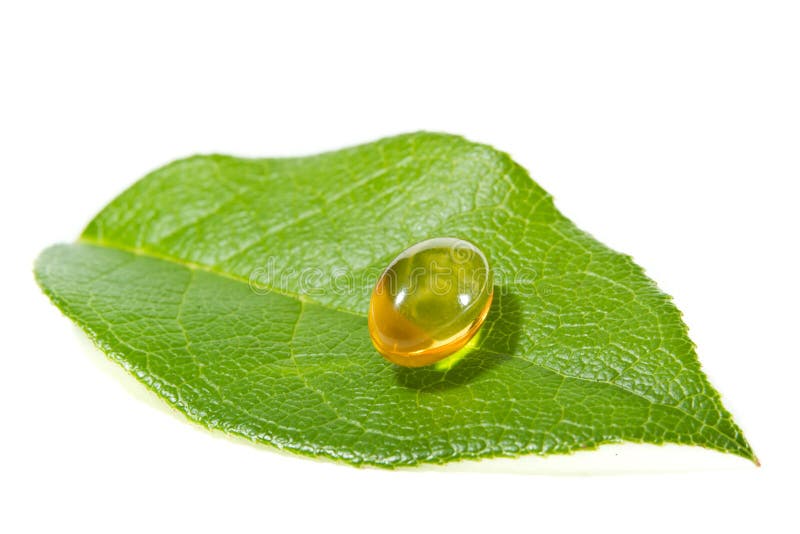 Natural oil supplement capsule with a green leaf isolated on a white background. Green herbal drug medicine stock images, royalty-free photos and pictures