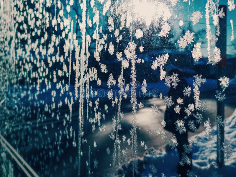 Frozen snowflakes on window glass