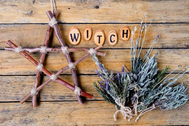 Natural Witch - rustic branch pentagram and dried herbs with the word Witch burnt letters on wooden background